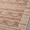 Close-up angled view capturing the rug’s corner and part of the patterned field with diamond border.