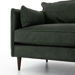 Detailed view of leather upholstery-wrapped arm with precise stitching