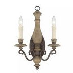 Rustic two-light wall sconce with Fossil Stone finish, elegant curves, and candle-style bulbs