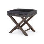 Detailed view of ottoman corner showcasing dark wood base and snugly wrapped leather cushion