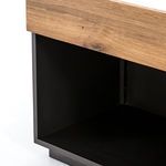 Detail of nightstand interior storage space with smooth matte black finish