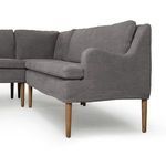 Close-up on linen texture and tapered wood leg with visible grain detail