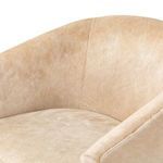 Close-up view of rounded back support and part of seat cushion in uniform buff hide