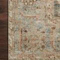 Detailed section of Margot Ocean Spice rug pattern showing neutral blue and spice tones on dark wood floor