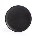 Top view of matte black ceramic salad plate with smooth finish and subtle natural imperfections
