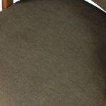 Detailed view of seat cushion texture with soft olive linen fabric