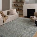 Wade Spa Sand Rug styled in modern living room with neutral sofas, fireplace, and open shelving