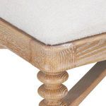Close-up of plush textured Frosted Alabaster fabric and detailed wood grain on stool corner