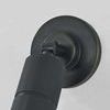 Close-up showing mechanical hinge and circular backplate edge of distressed bronze wall sconce