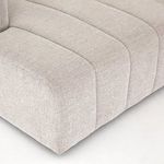 Close-up of textured upholstery fabric’s weave and channel stitching on low section corner