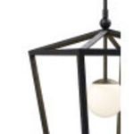 Blurred close-up emphasizing textured black iron frame and globe contrast