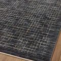 Detailed angled view focusing on the specific grid pattern and subtle color shifts at rug edge.