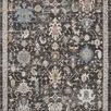 Traditional rug with charcoal background featuring vintage Turkish Oushak motifs in blue, cream, and rust tones