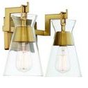 Close-up side angle on brass fixture and clear glass shade with filament bulb inside