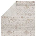 Kalindi Tribal rug folded corner revealing the light cream backing and front patterned side