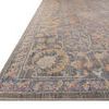 Low angle showing thin profile and detailed border of Rosemarie stone rug