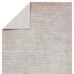Top corner folded to display the rug's lighter cream underside contrasting with textured top
