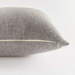 Side view highlighting white zipper detail along pillow edge