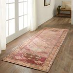 Rug swatch styled on wood floor next to window with natural light showcasing full pattern