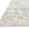 Close-up angled view of the rug’s border showing faded denim blue and fog colors with intricate detailing