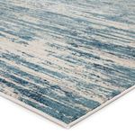 Close-up showing carved-like texture and detailed blue and ivory fibers of the rug's corner