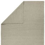 rug corner folded to show solid taupe-gray weave on both top and underside