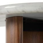 Side close-up of single acacia crescent leg supporting white marble surface