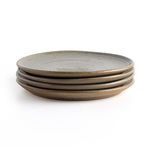 Set of four natural speckled clay dinner plates stacked, handmade with earthen texture