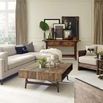 Living room scene with sectional sofa and rustic wood coffee table with decorative tray and candles