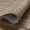 Rolled-up portion of Wade Brown / Stone Rug reveals backside and weave construction details