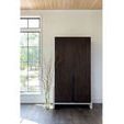 Shasta Wardrobe closed in bright room with large window and decorative tall clear vase with branches