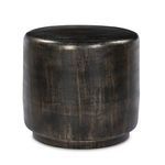 Angled side view illustrating the rounded shape and distressed bronze texture of the table
