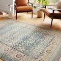 Jocelyn Sky rug placed in bright room with leather chairs and plant, showing scale and room context
