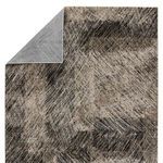 Partial underside flipped to reveal smooth gray backing contrasting the abstract front