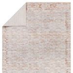Folded back corner revealing solid cream underside of the rug
