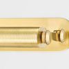 Close-up of brass textured cylindrical light head and adjustable arm detail on oval base