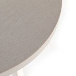 wide shot of table emphasizing geometric base and circular top in bright setting