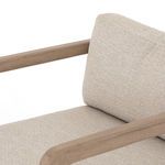 Close-up on top cushion seam and fabric texture against wooden armrest