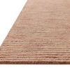 Close-up angled view showing thick textured pile and tones of terracotta stripes