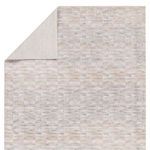 Back view of Luray rug displaying neutral beige backing and folded corner