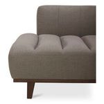 Close-up view on Bennett Daybed’s rounded edge armrest and tapered wood leg