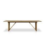 Enders Outdoor Dining Table with minimalistic wood stool beside in garden with gravel ground