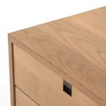 Close-up of drawer front with squared iron satin brass hardware inset in oak drawer