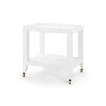 White lacquered Isadora Tea Table with open rectangular frame, lower shelf, and brass caster wheels