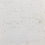 Close-up showing fine grain and subtle color variations in the white marble tabletop