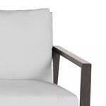 Tight close-up of sofa cushion seating and back cushions with dark woodgrain aluminum armrest