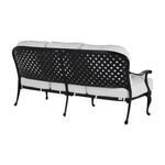 Rear angle highlighting the curved black aluminum frame and lattice back paired with thick cushions