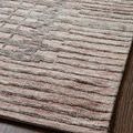 Textured corner close-up of Yeshaia Blush Taupe rug highlighting the raised taupe pattern on blush background