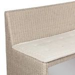 Top edge of rattan backrest with fabric cushion corner detail and tufting