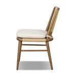 Greylin Dining Chair side profile highlighting wood frame curve and cushion thickness